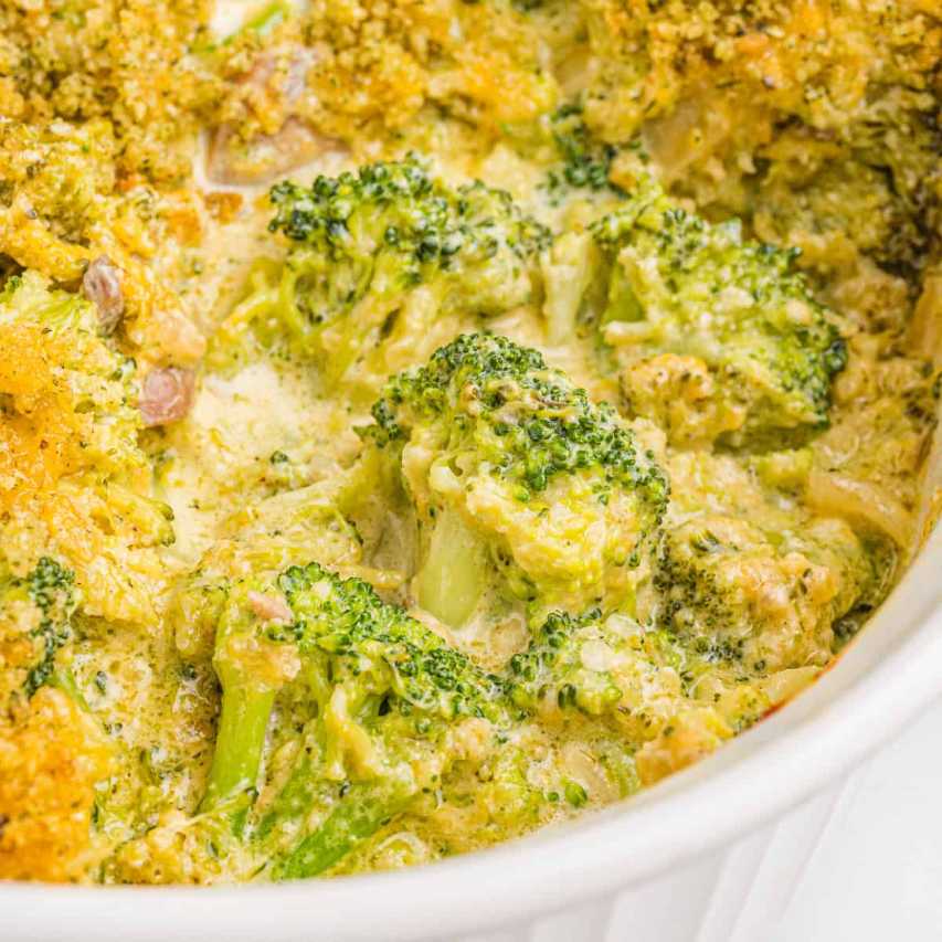 Creamy broccoli cheese casserole with a golden crumb topping and melted cheese in a baking dish